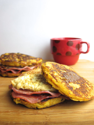 Two breakfast sandwiches with ham, egg, and "buns" made from pancakes.