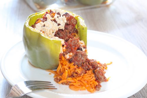 Spaghetti Stuffed Peppers | Spiralized sweet potato serves as gluten free noodles which are stuffed into green peppers, topped with meat sauce and optional cheese, then baked. | eatsomethingdelicious.com