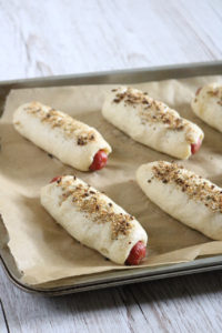 Onion Sesame Bagel Dogs | Hot dogs wrapped in a chewy, yeast free bagel dough with roasted garlic and onion baked right in then topped with an onion sesame mixture. Paleo friendly. | eatsomethingdelicious.com