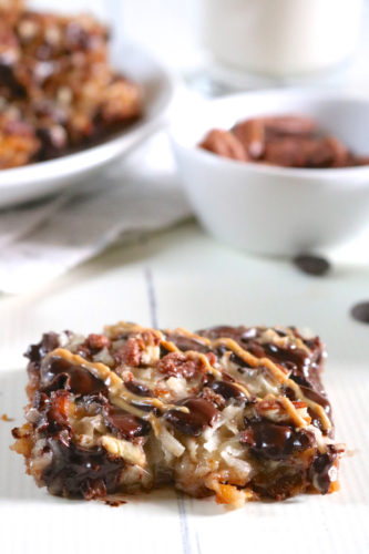 Magic Cookie Bars | An easy version of magic cookie bars made gluten free and dairy free with optional candied nuts and sunbutter drizzle. | eatsomethingdelicious.com