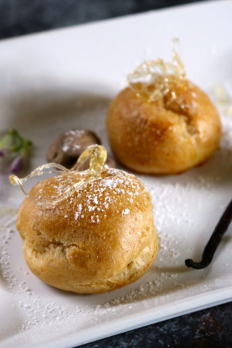 Vanilla Nutmeg Cream Puffs | Delicate golden cream puffs filled with a vanilla nutmeg custard. Although these are gluten free and dairy free, they are just as good as the original! | eatsomethingdelicious.com