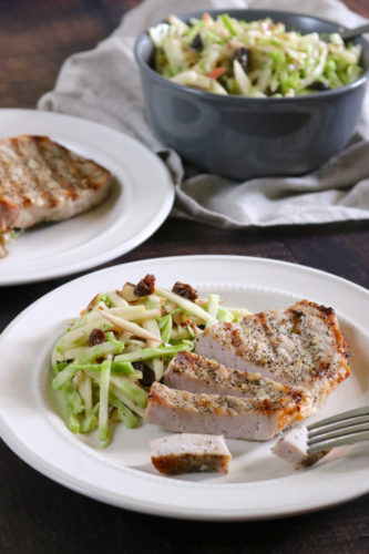 Garlic Pepper Pork Chops with Broccoli Apple Slaw | These grilled pork chops are a summery version of the classic pork and apple pairing where the apple is incorporated into a fresh broccoli slaw on the side. | eatsomethingdelicious.com