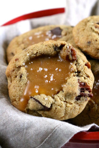Salted Caramel Filled Turtle Cookies | Soft baked gluten free turtle cookies with chocolate and pecans are dented in the center to make room for lots of dairy free salted caramel sauce! | eatsomethingdelicious.com