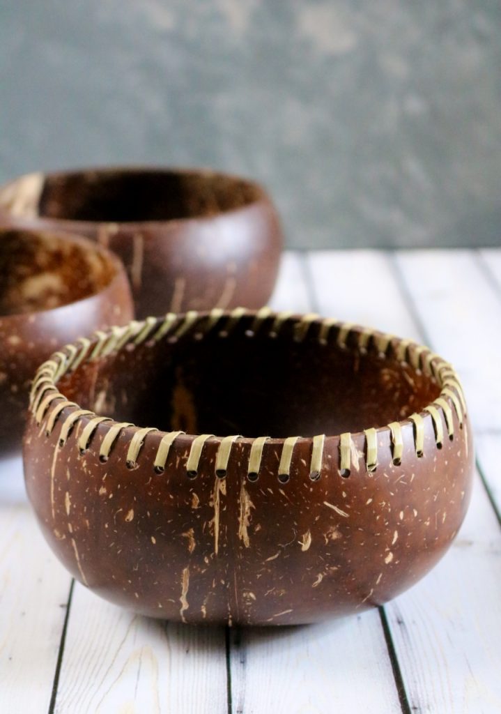 A fiber laced coconut bowl with two plain coconut bowls in the background.
