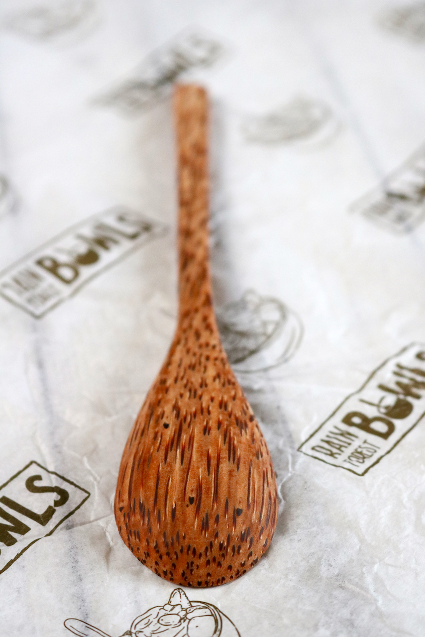 Coconut timber spoon laying upside down.